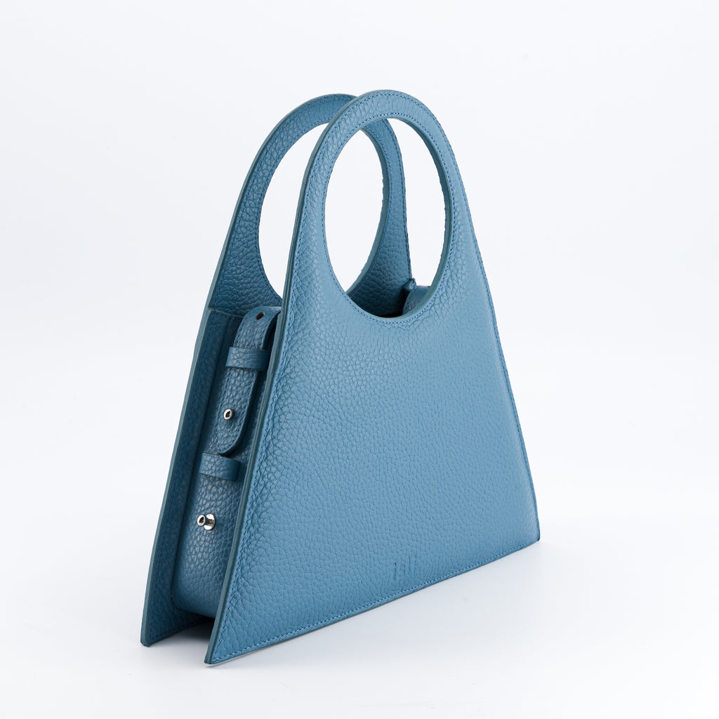Tobkal Bag in Teal, angled view showing the side gusset and stud fastenings, ISLI Studio