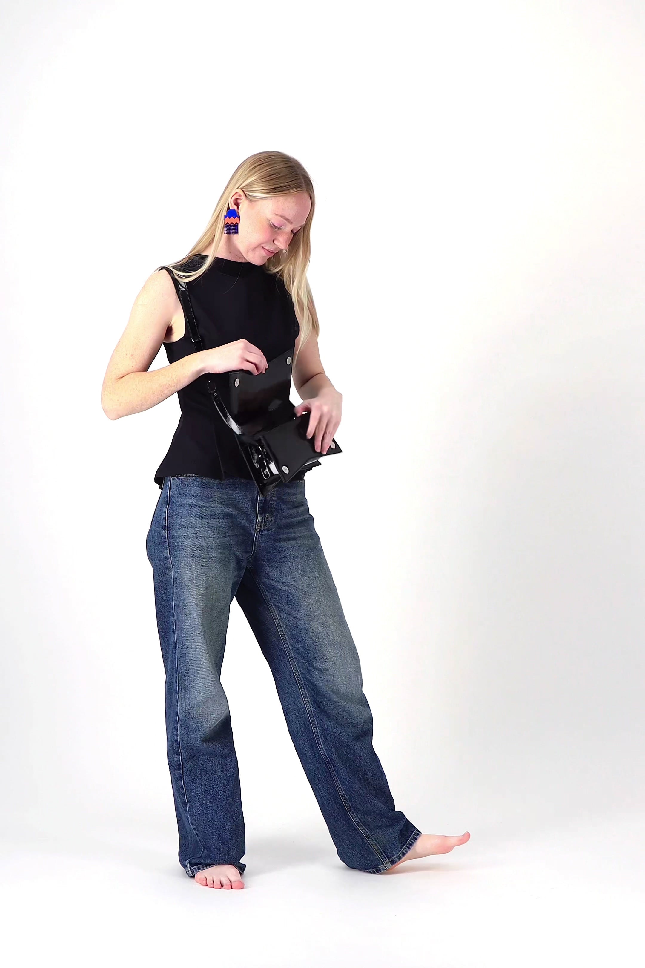 Jelija Bag in Cobalt Blue worn at the waist as a clutch, handmade by ISLI Studio