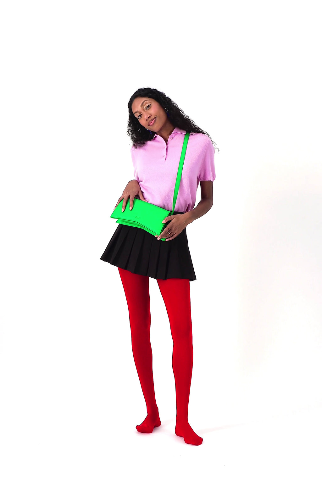 Jelija Bag in Green worn at the waist as a clutch, handmade by ISLI Studio