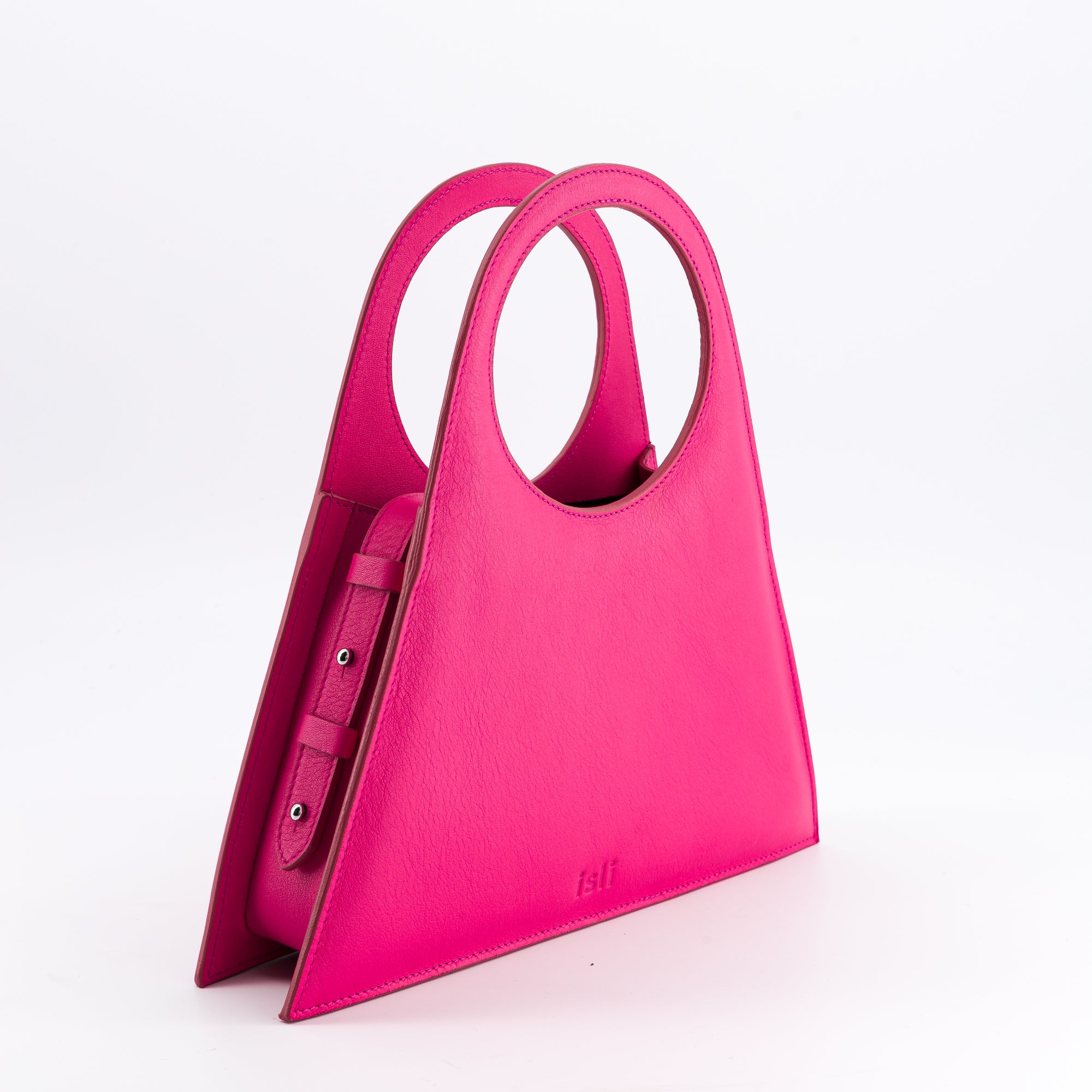 Tobkal Bag in Hot Pink, angled view showing the side gusset and stud fastenings, ISLI Studio