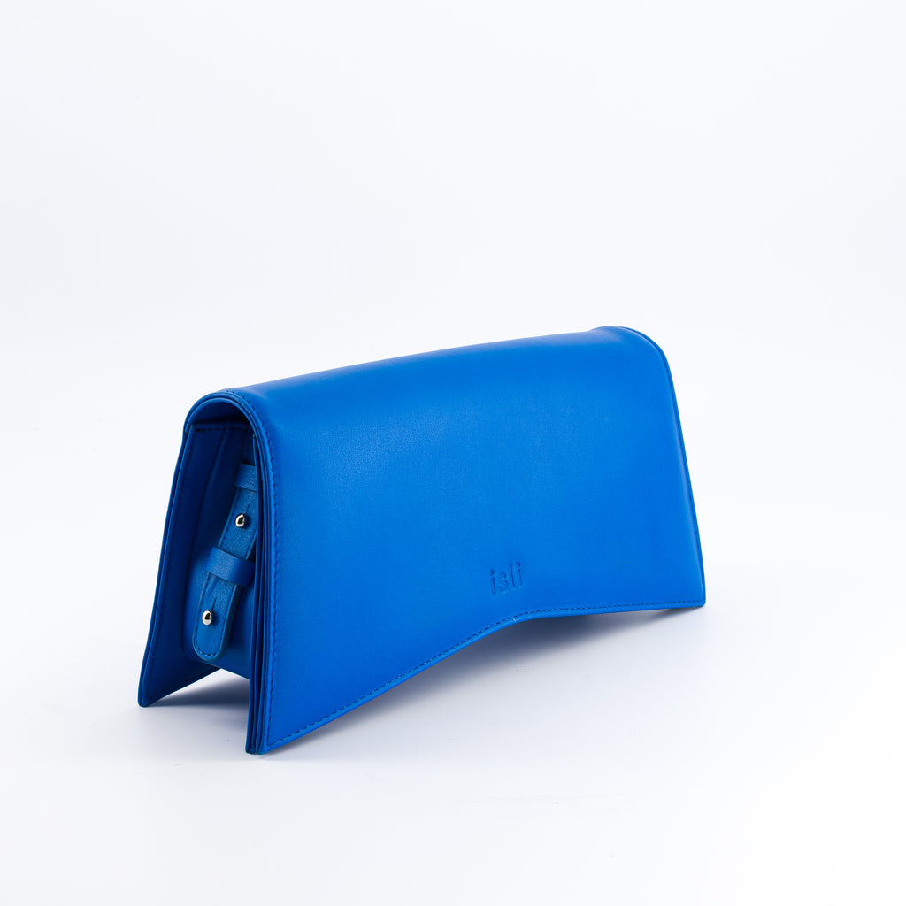 Jelija Bag in Cobalt Blue, angled view showing the adjustable strap and metal clasp, ISLI Studio