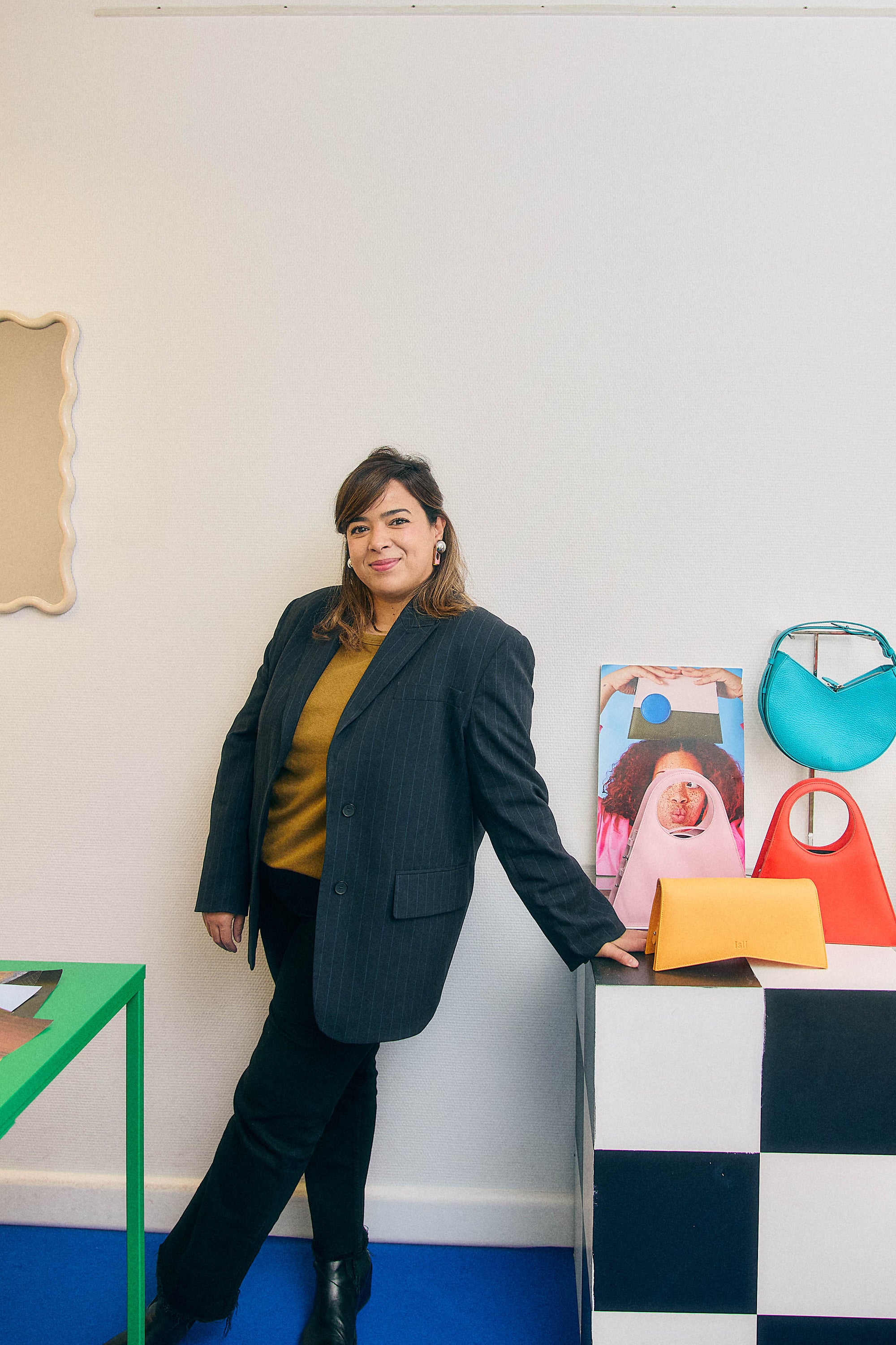 Karima, founder of ISLI Studio, in the showroom beside her leather bags