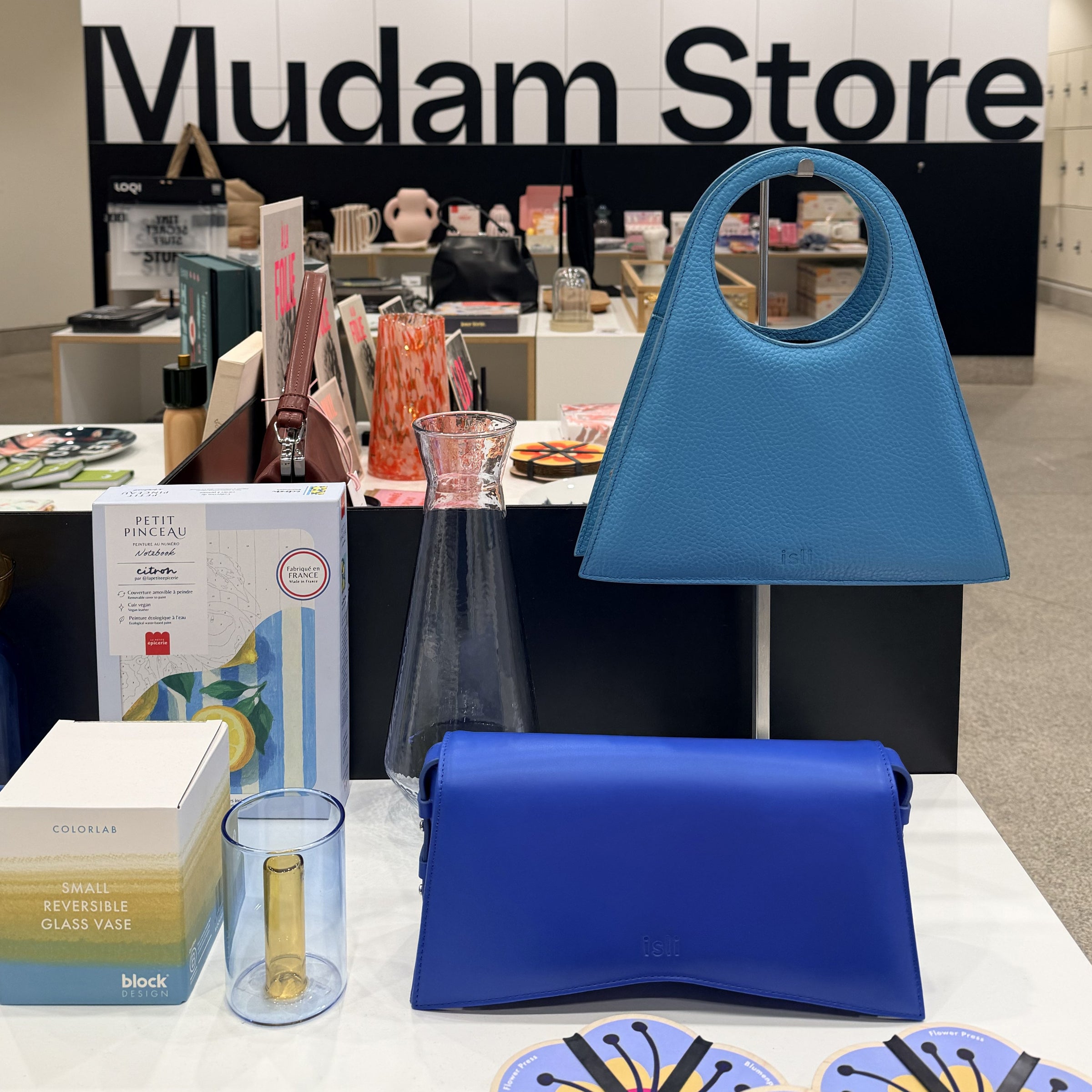 ISLI blue leather bags on a table at the Mudam Store in Luxembourg